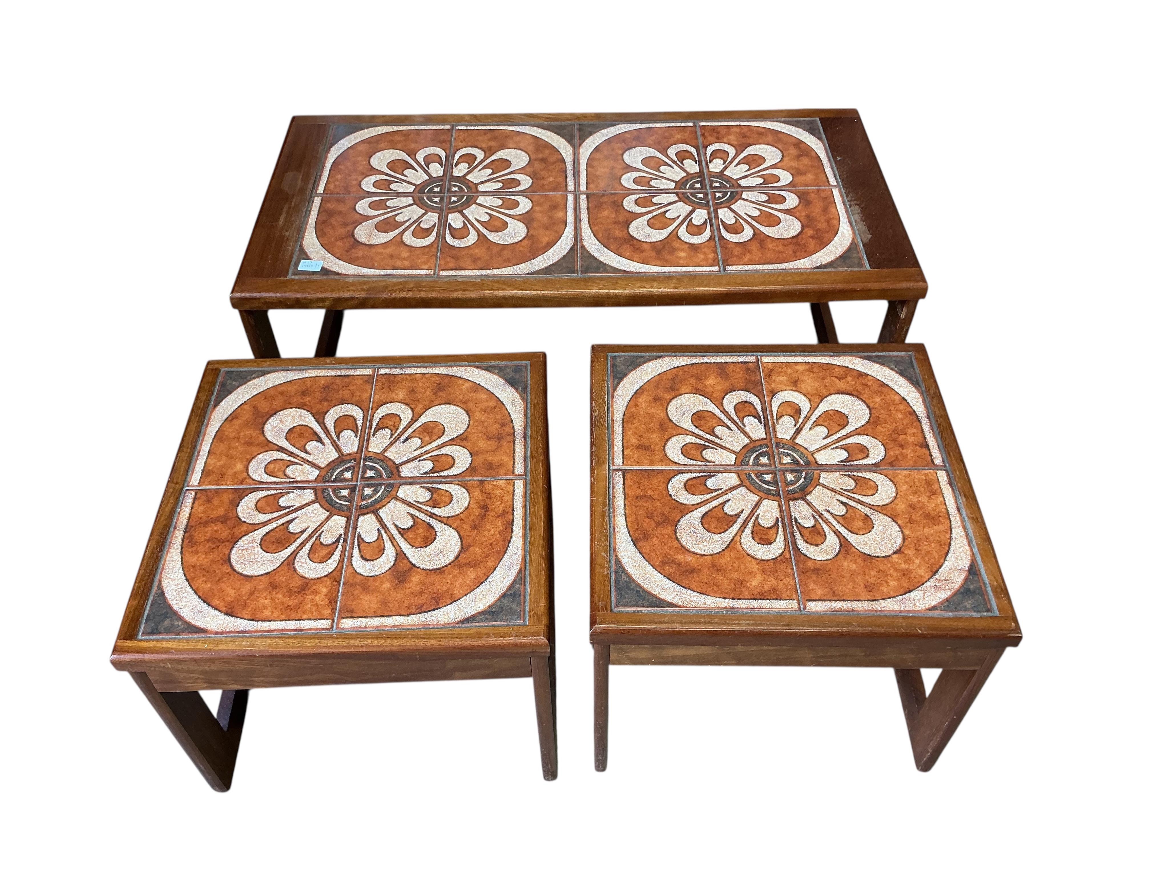 A nest of three mid century tiled top teak tables, width 96cm, depth 48cm, height 40cm